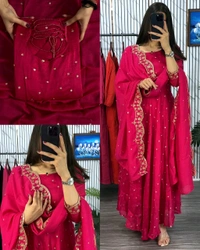 Introducing our Striking Vichitra Anarkali Adorned with Exquisite Embroidery. Paired with a delicate Border dupatta, this ensemble exudes elegance and sophistication, perfect for any special occasion - Burgundy, S