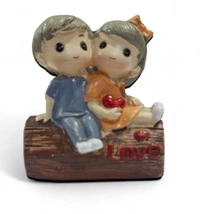Cute Couple Miniature Sitting On Wood 