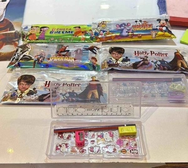 Plastic pencil boxes with stationery in pouch packing.Designs random only