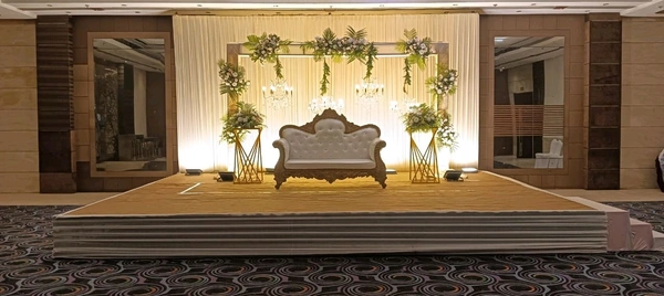 Classic Floral Wedding Stage with Chandeliers & Warm Backdrop