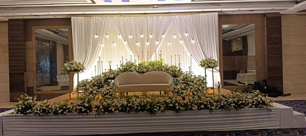 Luxury Floral Wedding Stage with Candle Setup & Premium Drapes