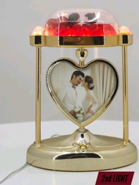 a personalized heart-shaped LED photo frame lamp with a rotating center photo display.