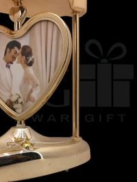 a personalized heart-shaped LED photo frame lamp with a rotating center photo display.