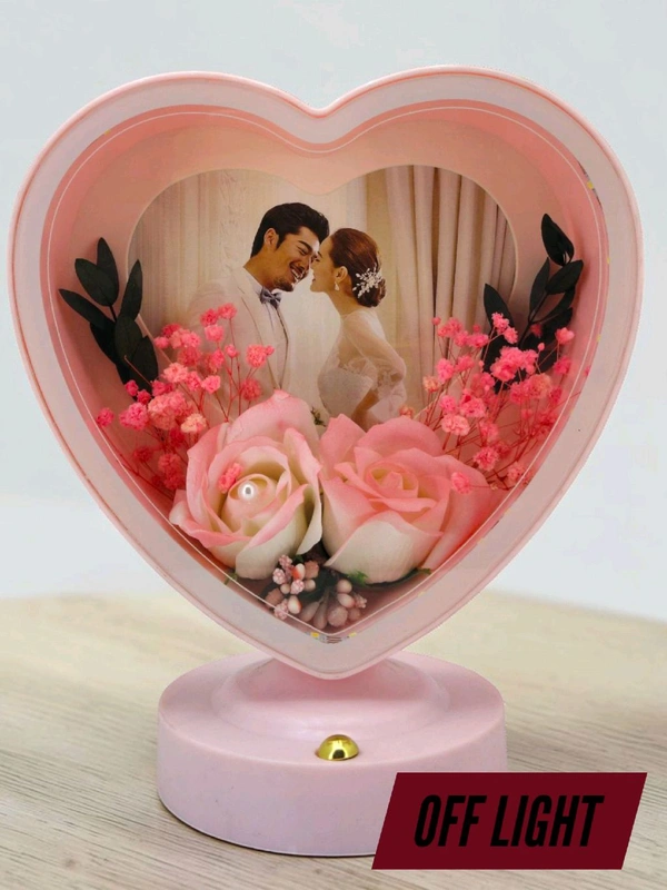 personalized heart-shaped LED photo frame with decorative floral elements, similar to products offered by brands like ND Enterprise or Archies.