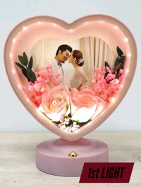 personalized heart-shaped LED photo frame with decorative floral elements, similar to products offered by brands like ND Enterprise or Archies.