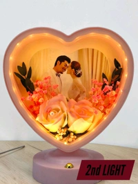 personalized heart-shaped LED photo frame with decorative floral elements, similar to products offered by brands like ND Enterprise or Archies.