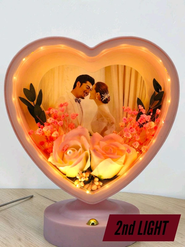 personalized heart-shaped LED photo frame with decorative floral elements, similar to products offered by brands like ND Enterprise or Archies.