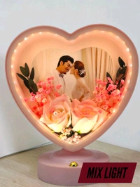 personalized heart-shaped LED photo frame with decorative floral elements, similar to products offered by brands like ND Enterprise or Archies.