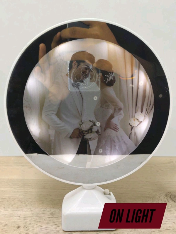 TaffHome Magic Mirror with Photo Frame is a functional table mirror that turns into an illuminated photo frame when connected to electricity.