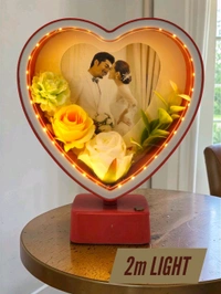 heart-shaped LED photo frame, often referred to as a "magic mirror" frame, designed for personalized gifting and home decor with built-in flowers and lighting.