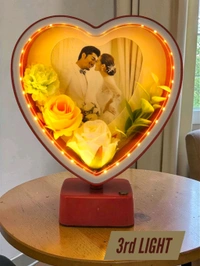 heart-shaped LED photo frame, often referred to as a "magic mirror" frame, designed for personalized gifting and home decor with built-in flowers and lighting.