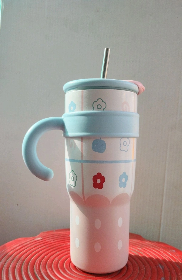 stainless steel double-wall vacuum insulated tumbler with a handle, straw, and decorative pattern.