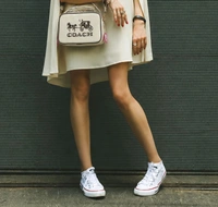 This is a Coach Women's Jes Crossbody bag featuring the iconic Horse and Carriage.