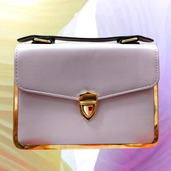 This Light Purple faux leather crossbody satchel by The Rare Bird features a metallic gold frame accent and a turn lock closure.