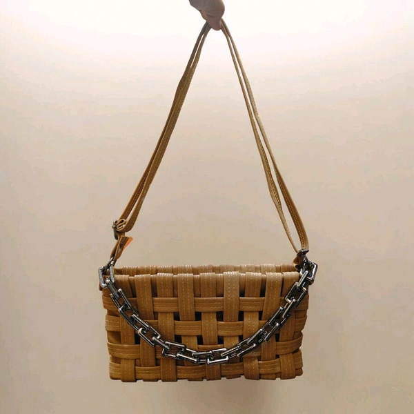 This Brown generic Shilpikraft shoulder sling bag features a unique woven pattern and a prominent silver chain strap.