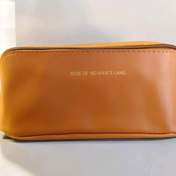 This brown PU leather cosmetic bag is branded with "ROSE OF NO MAN'S LAND.