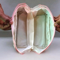 This Pink. PU leather cosmetic bag is branded with "ROSE OF NO MAN'S LAND.