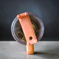 This 40-ounce stainless steel tumbler features a light Pink color and a sturdy handle.2086