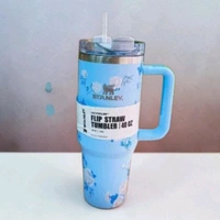 This Stanley x LoveShackFancy tumbler features a whimsical blue floral print and a convenient handle.2087