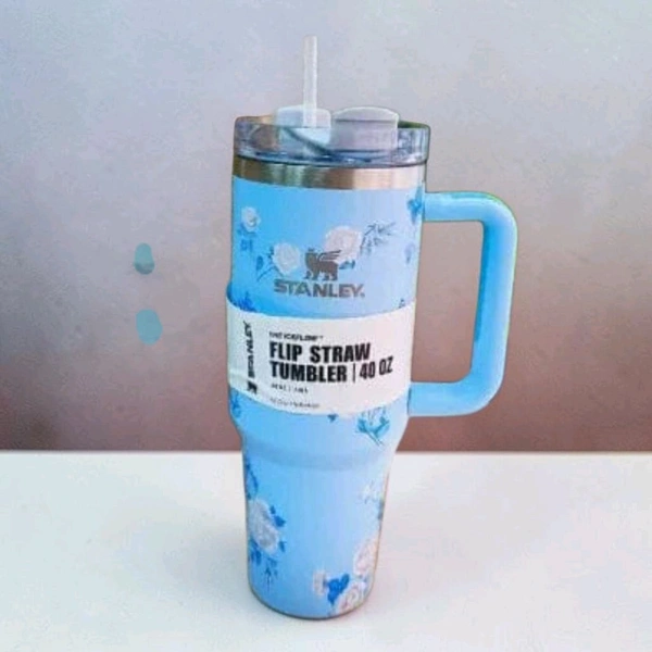 This Stanley x LoveShackFancy tumbler features a whimsical blue floral print and a convenient handle.2087