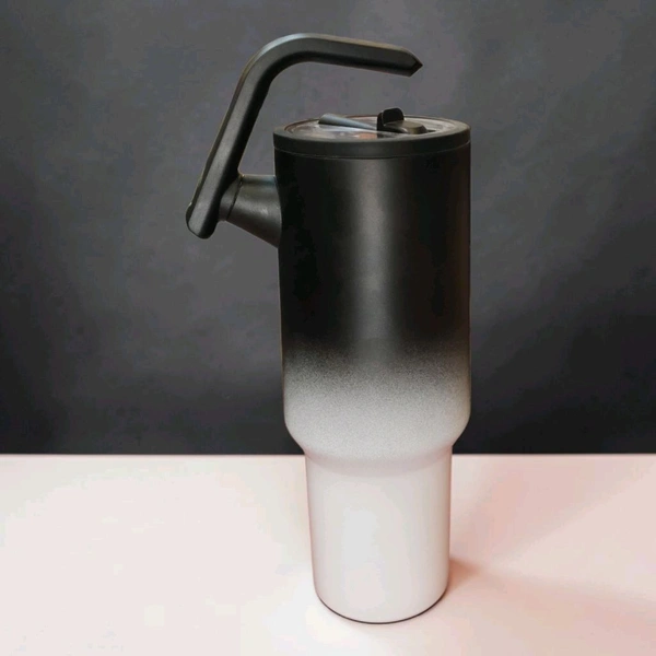 This tumbler is similar to 40oz stainless steel models from brands like CYNVEXA or Simple Modern, featuring a matte black to white gradient finish and a large handle.