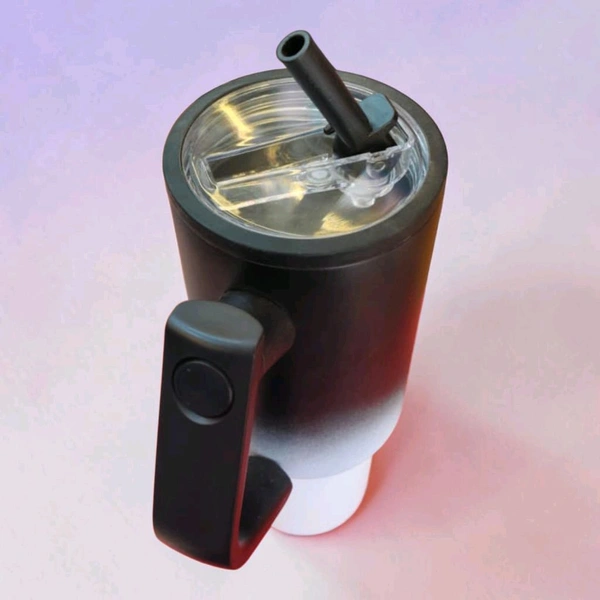 This tumbler is similar to 40oz stainless steel models from brands like CYNVEXA or Simple Modern, featuring a matte black to white gradient finish and a large handle.