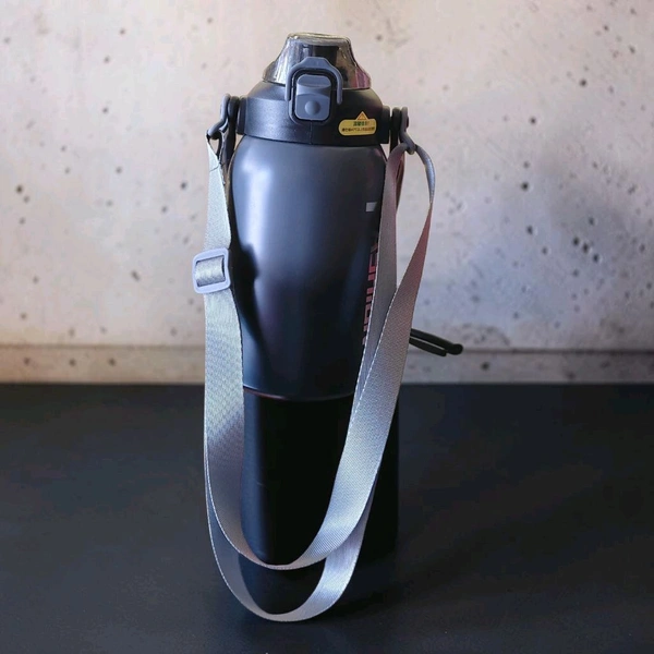 This is a Mumiguan 44-ounce insulated water bottle featuring a grey-black gradient design and a top carry handle.