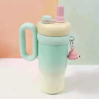 This 850ml stainless steel kid's tumbler features a leak-proof design with a character-themed, pastel green and yellow finish.